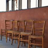 Set of 5 mismatched straw chairs.