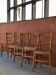 Set of 5 mismatched straw chairs.