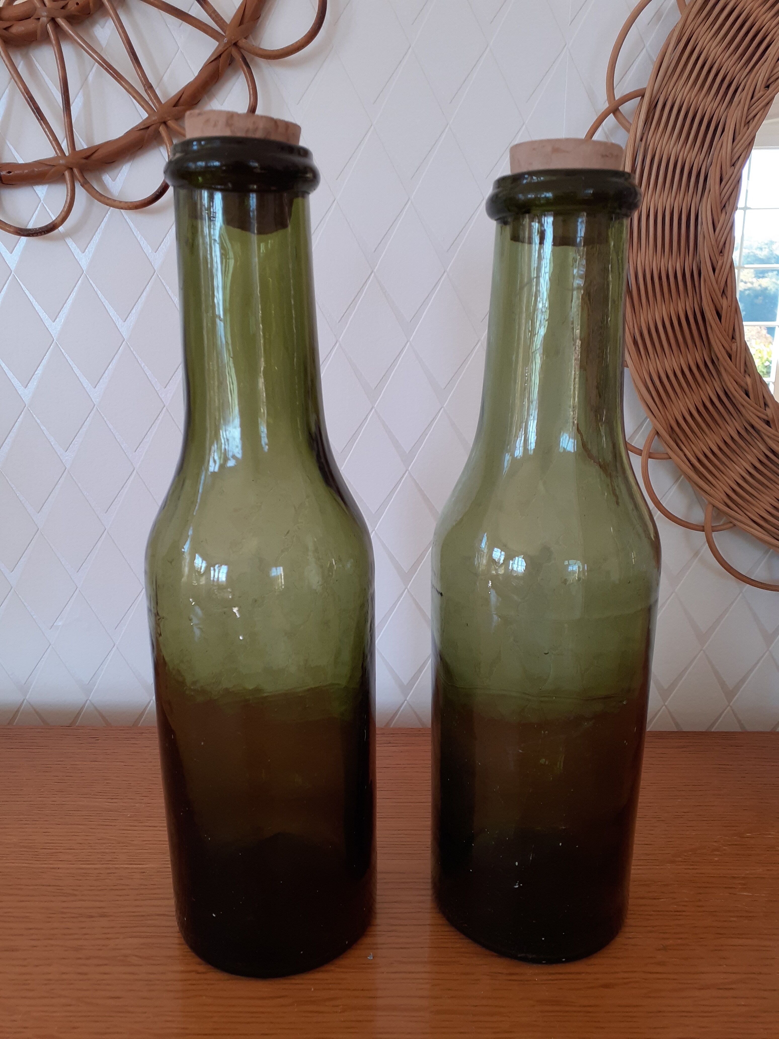 Pair of green bottles made of bubbled blown glass