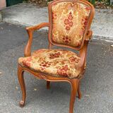 Louis XV armchair in carved solid wood and red and yellow fabric