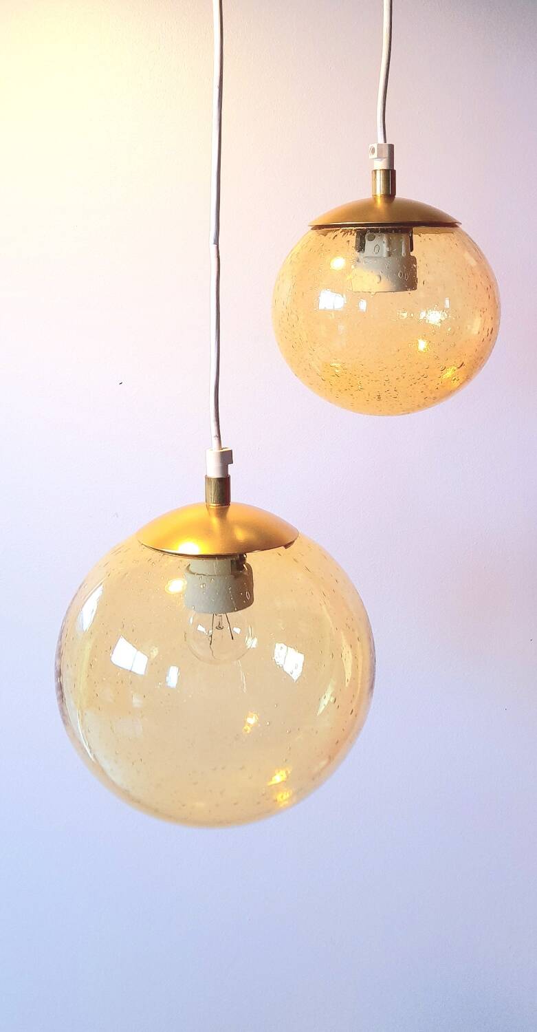 Set of 2 bubbled amber glass globe pendants