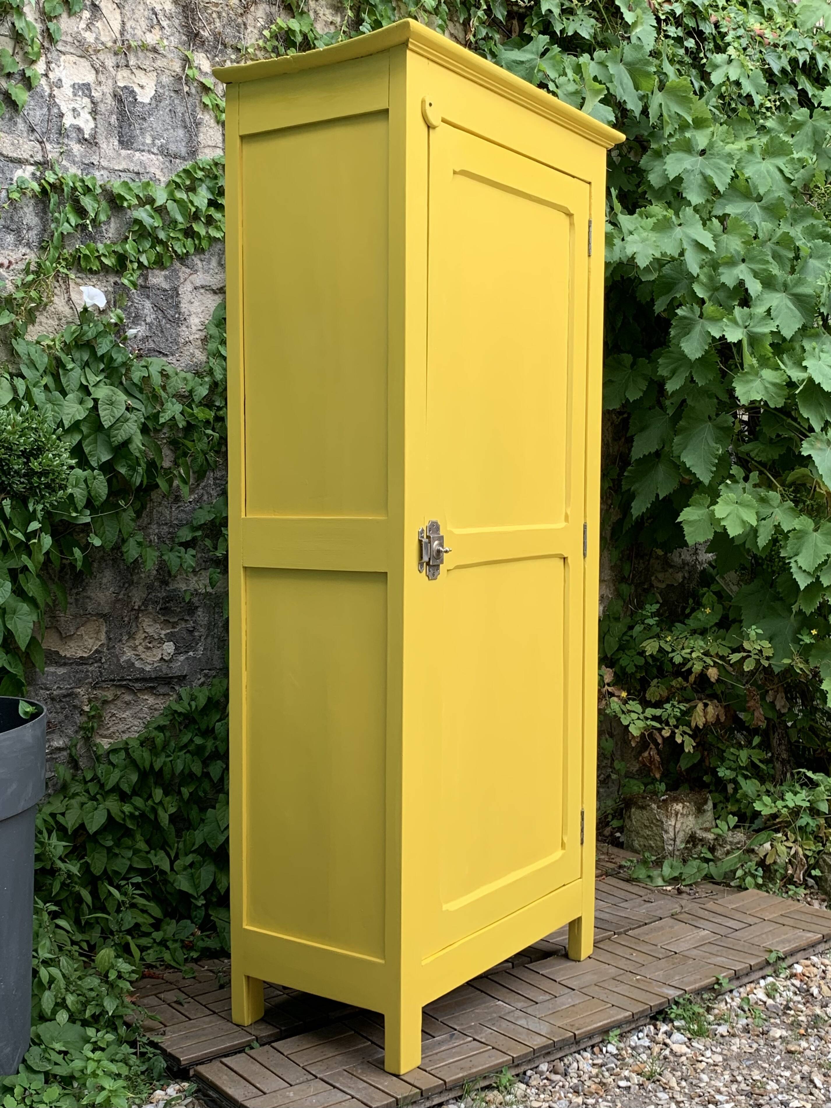 Antique powder yellow Parisian bonnetière wardrobe.