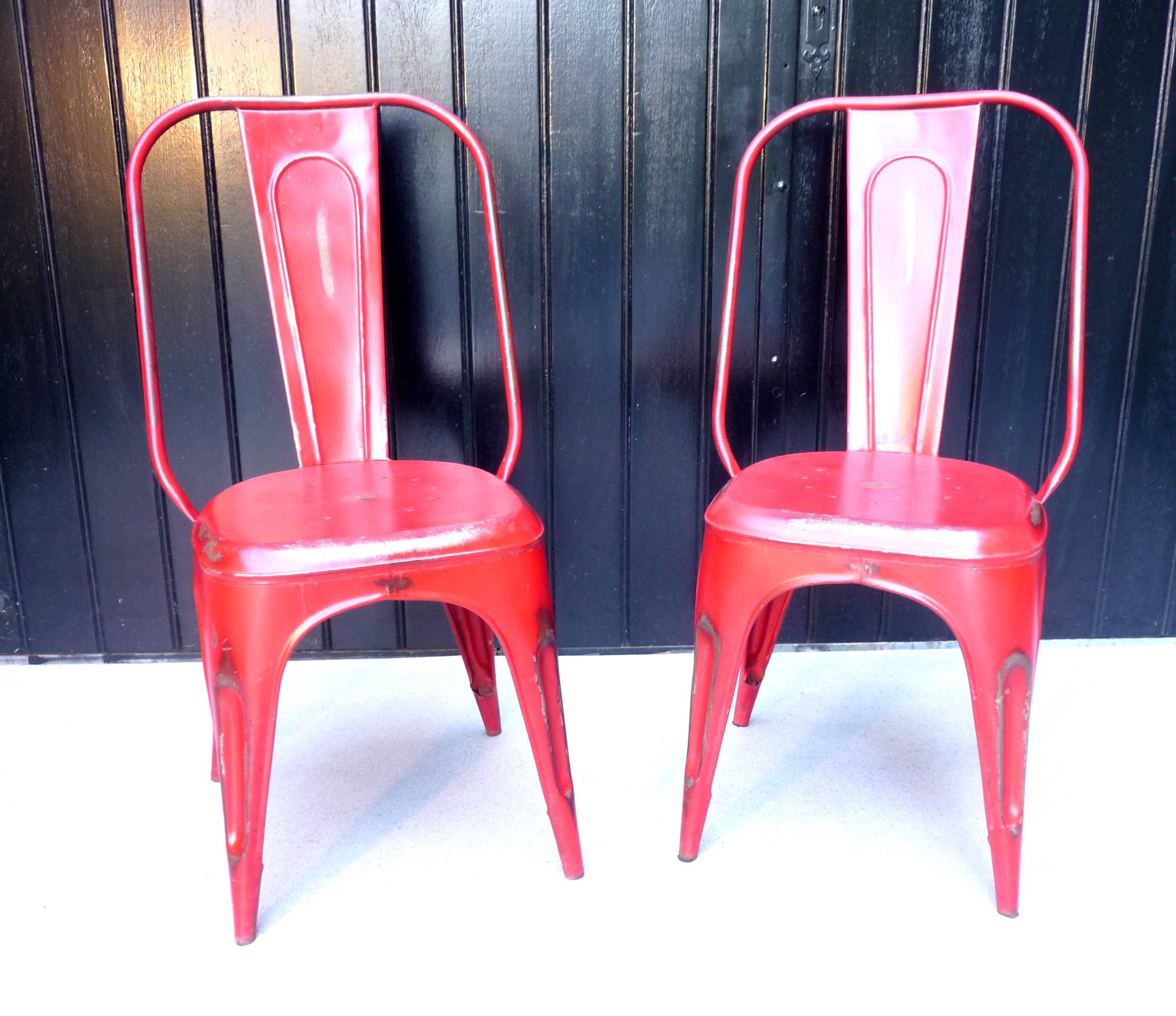 Pair of red stackable metal chairs