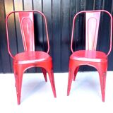 Pair of red stackable metal chairs