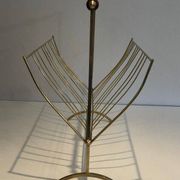 Brass and wood magazine rack, in the style of Cesare Lacca.
