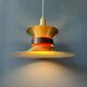 Large UFO flying saucer pendant light with orange light.