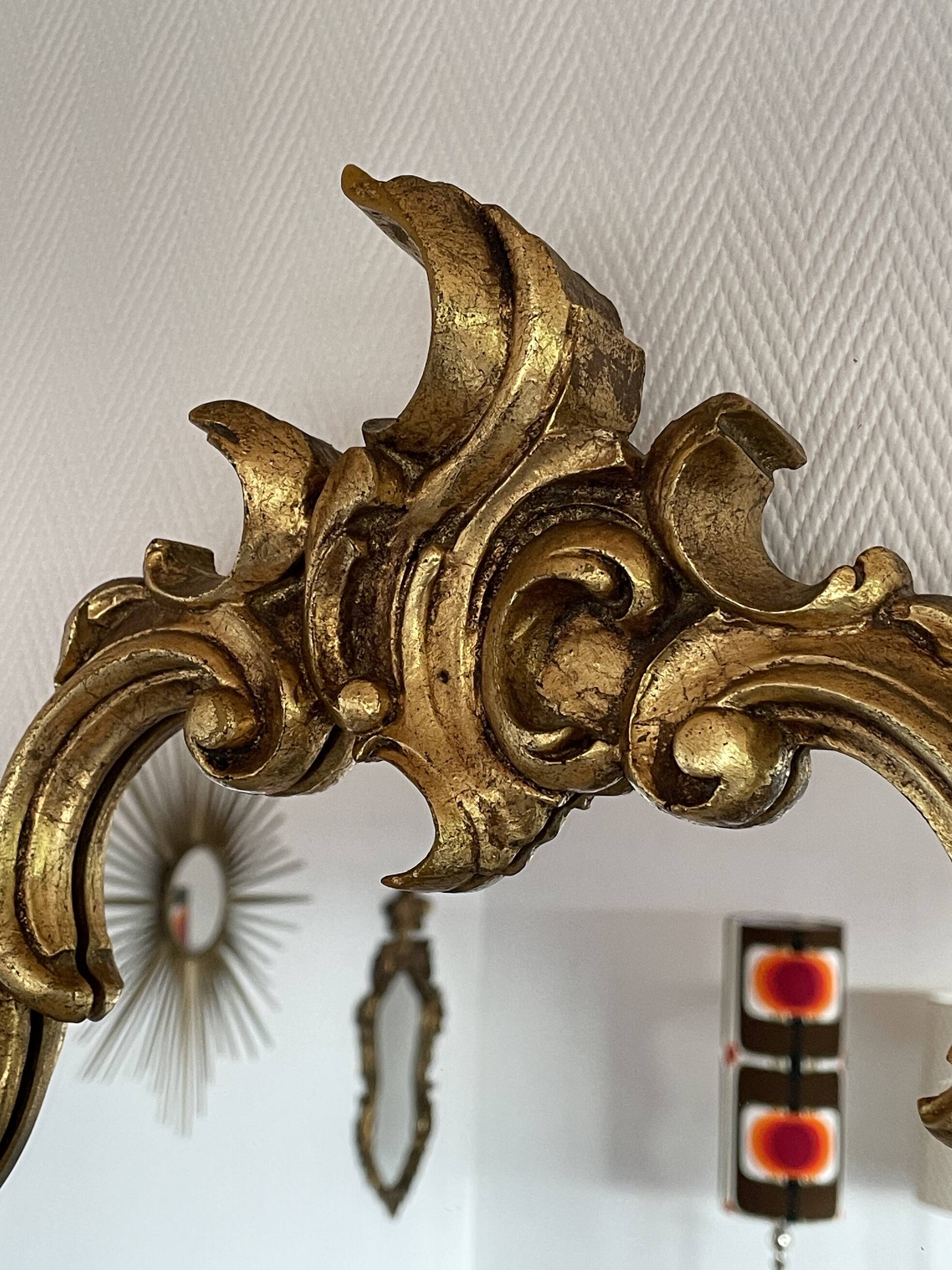 Old baroque style wall mirror with golden moldings