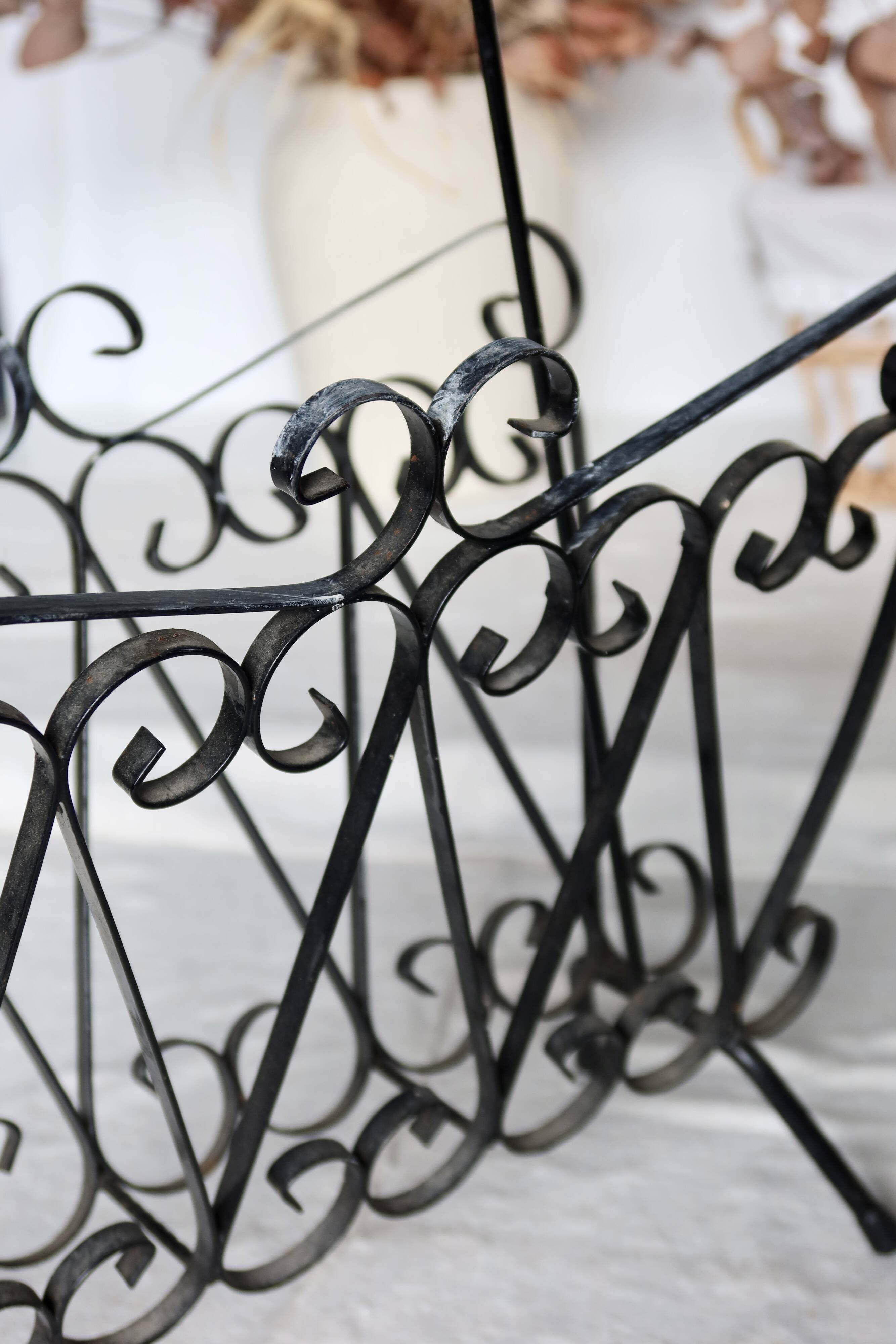 Vintage black metal scroll magazine rack