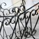 Vintage black metal scroll magazine rack