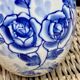 Decorative egg in white porcelain decoration blue flowers
