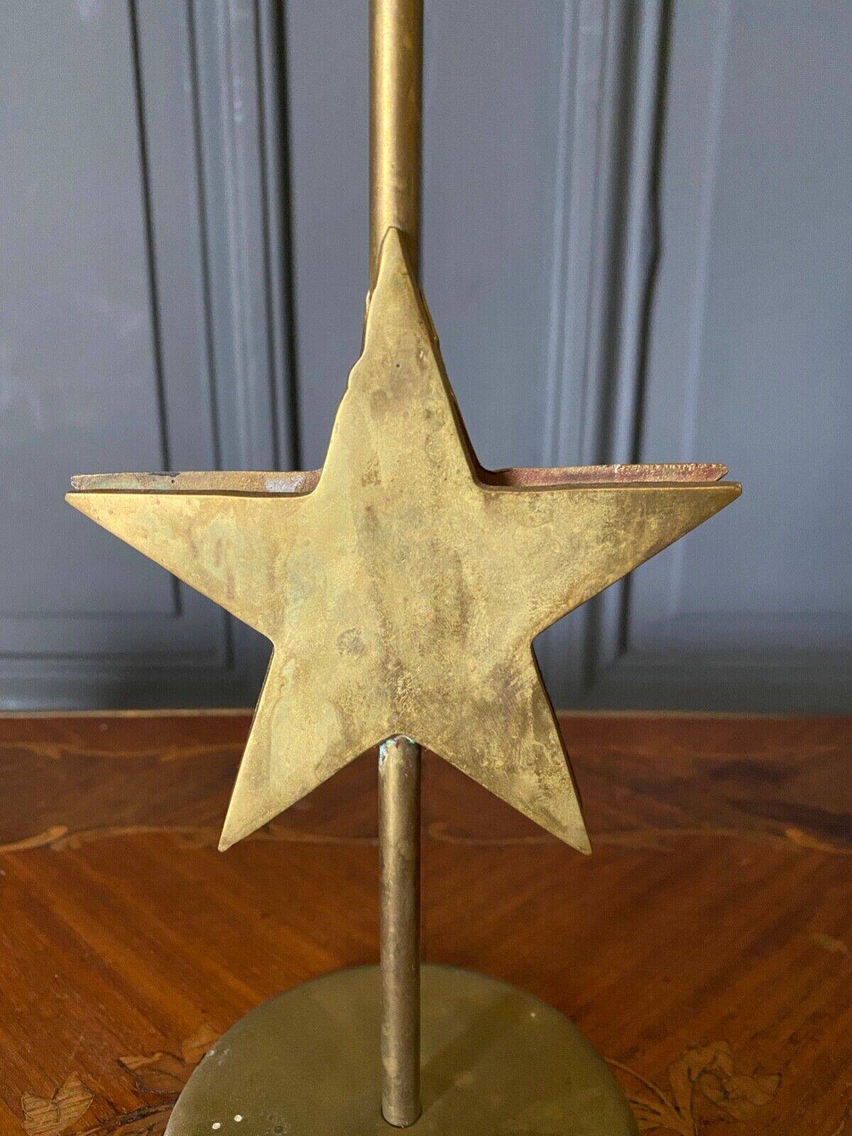 Pair of brass candlesticks decorated with 20th century stars