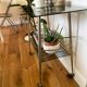 Vintage brass and smoked glass dessert trolley on wheels.