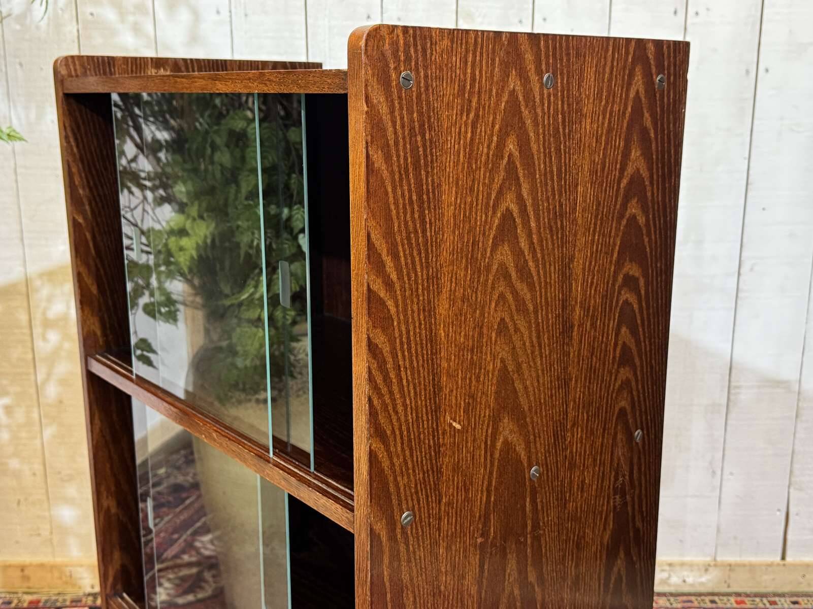 Small English oak library from the 1960s with sliding doors.