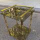 Vintage side table with smoked glass and sculpted golden brass, Hollywood Regency style.