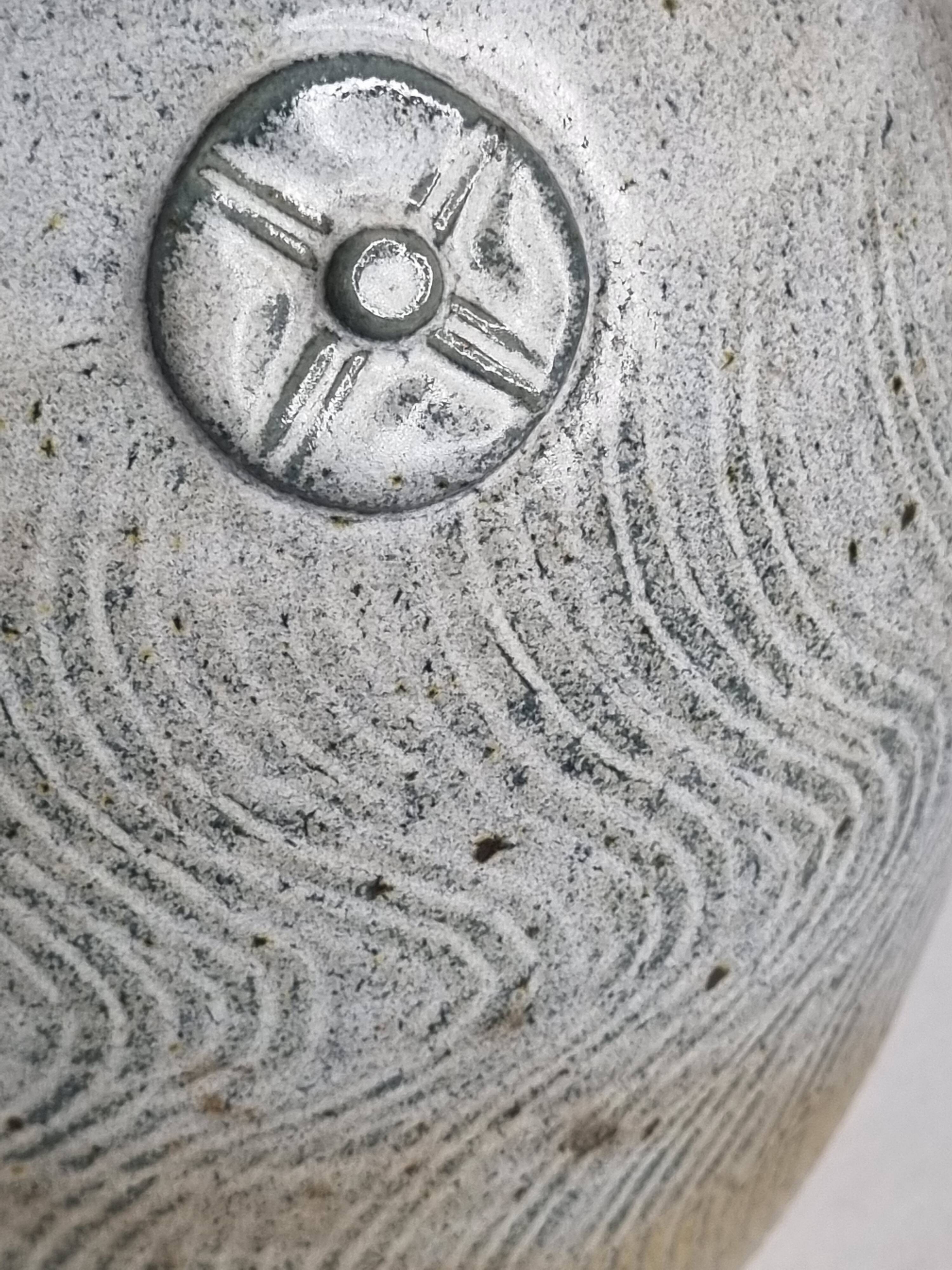 Stoneware vase signed by Sylvie Dufour, incised decoration and relief medallions, 28 cm.