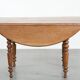 Antique English drop-leaf dining table made of walnut with elegant legs