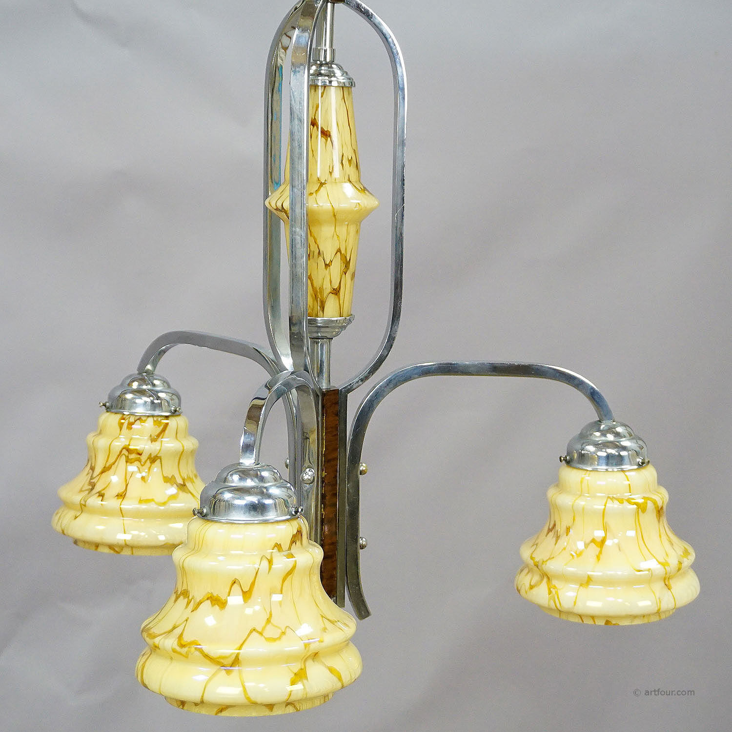 Antique Art Deco chandelier with three glass lampshades.