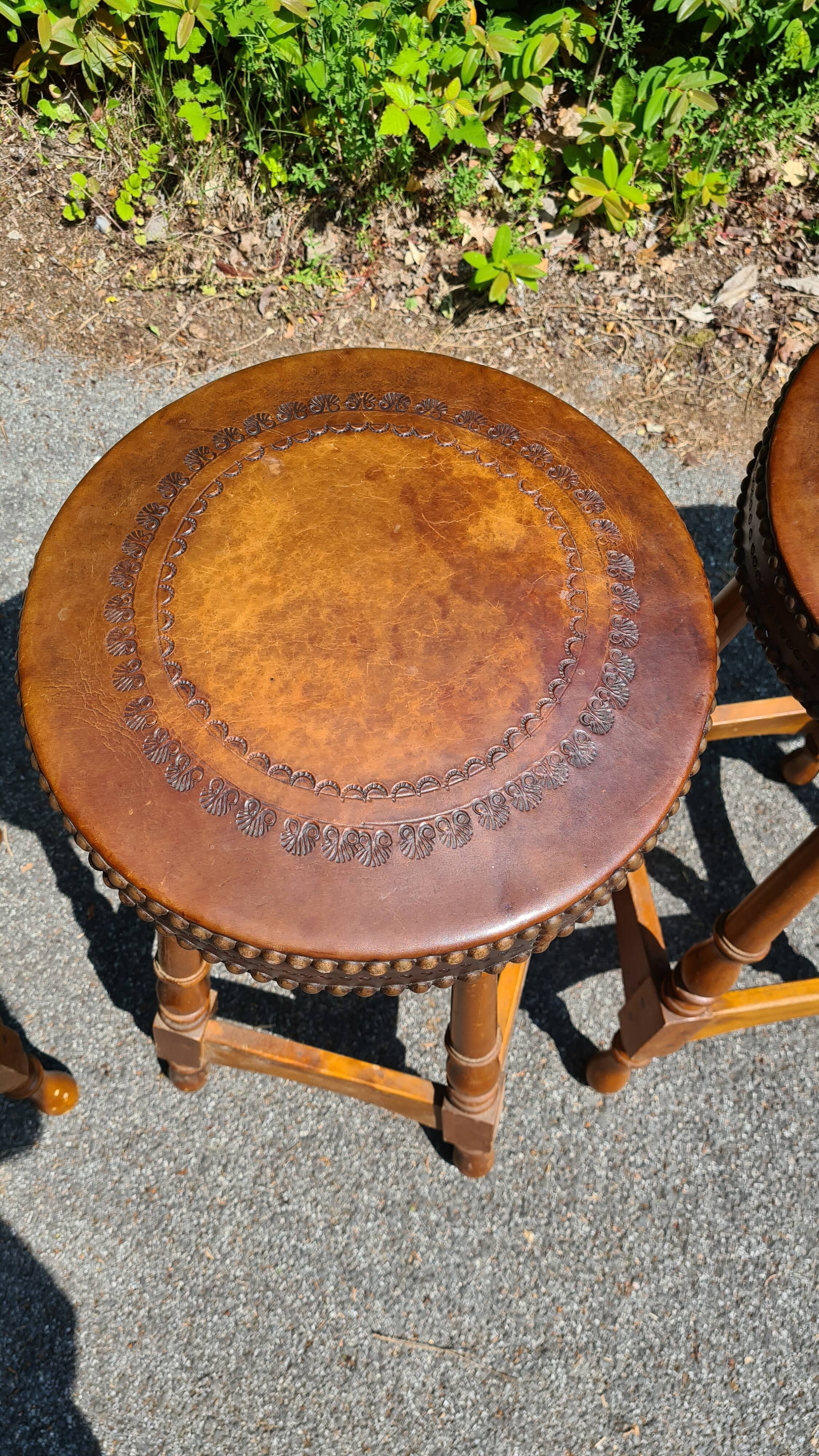 4 old leather and wood stools