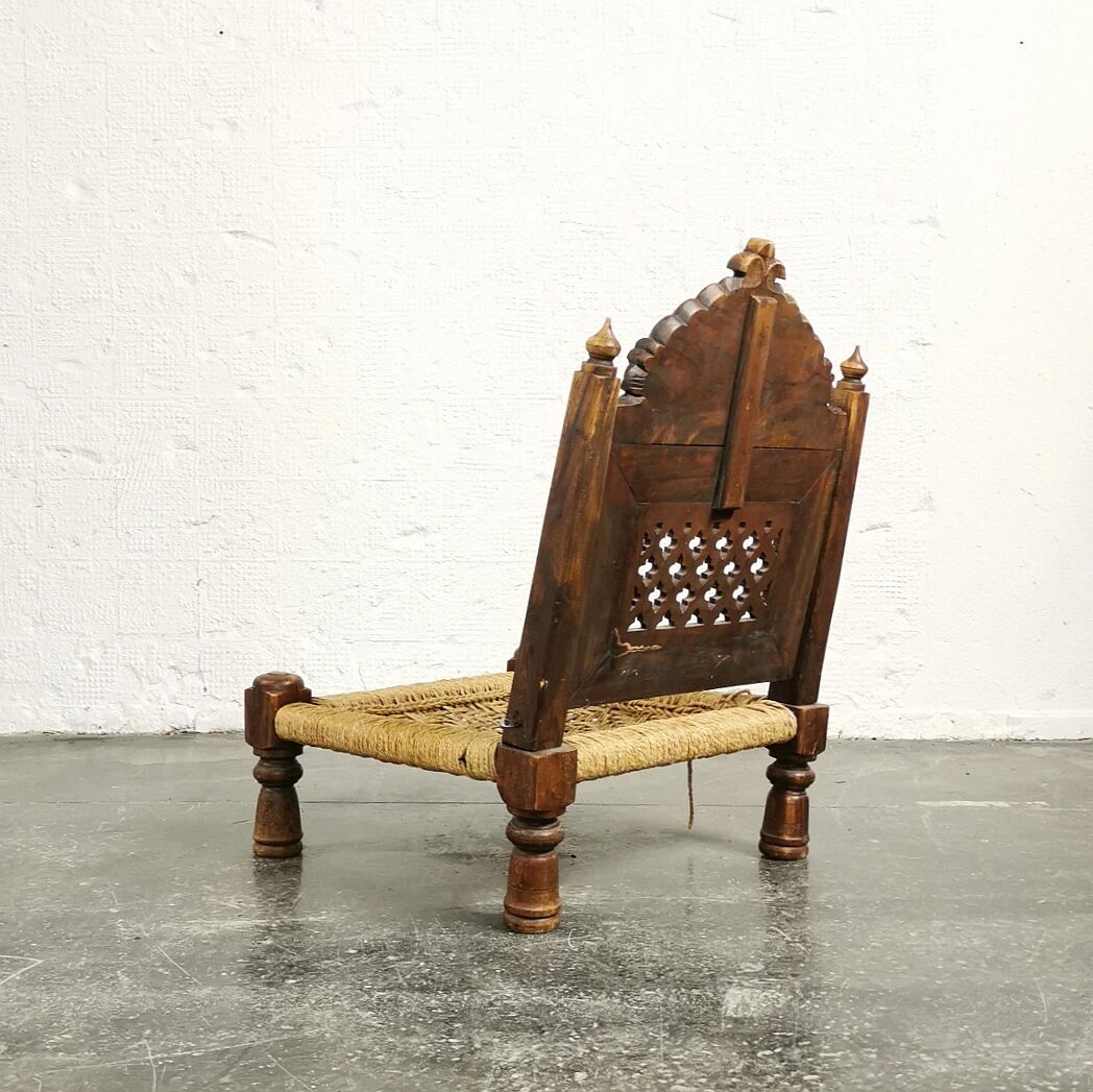 Ancient ethnic chair made of solid wood and rope