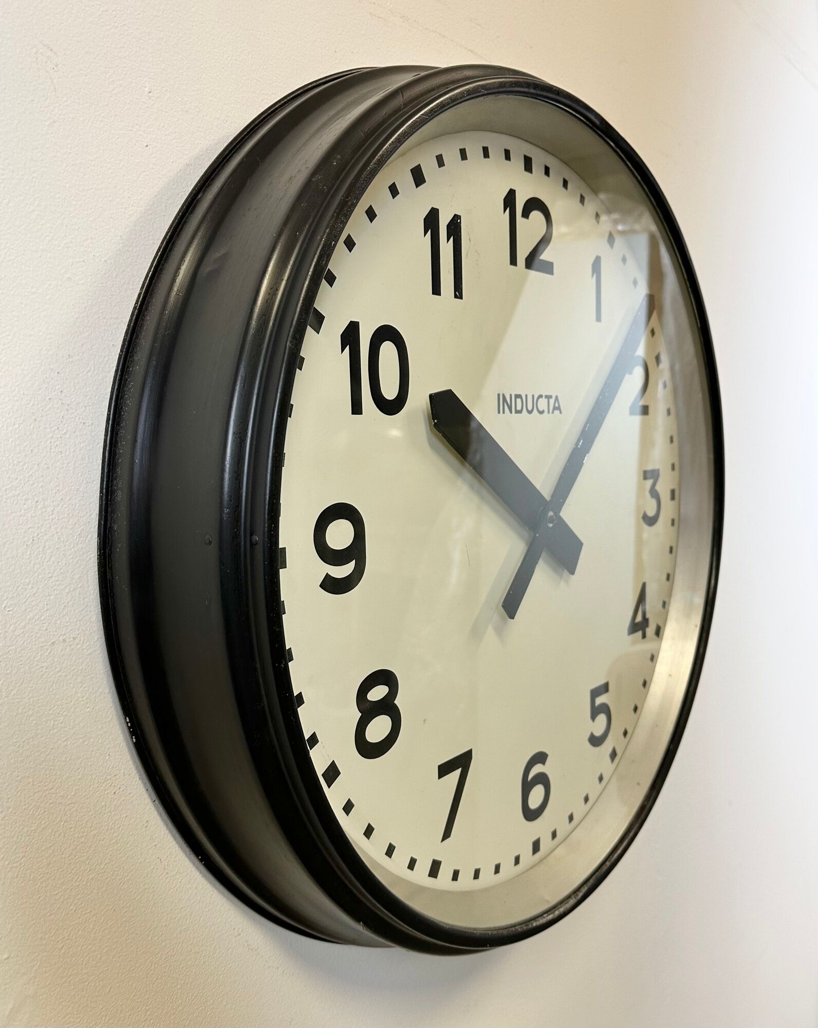 Black swiss industrial wall clock from inducta, 1960s