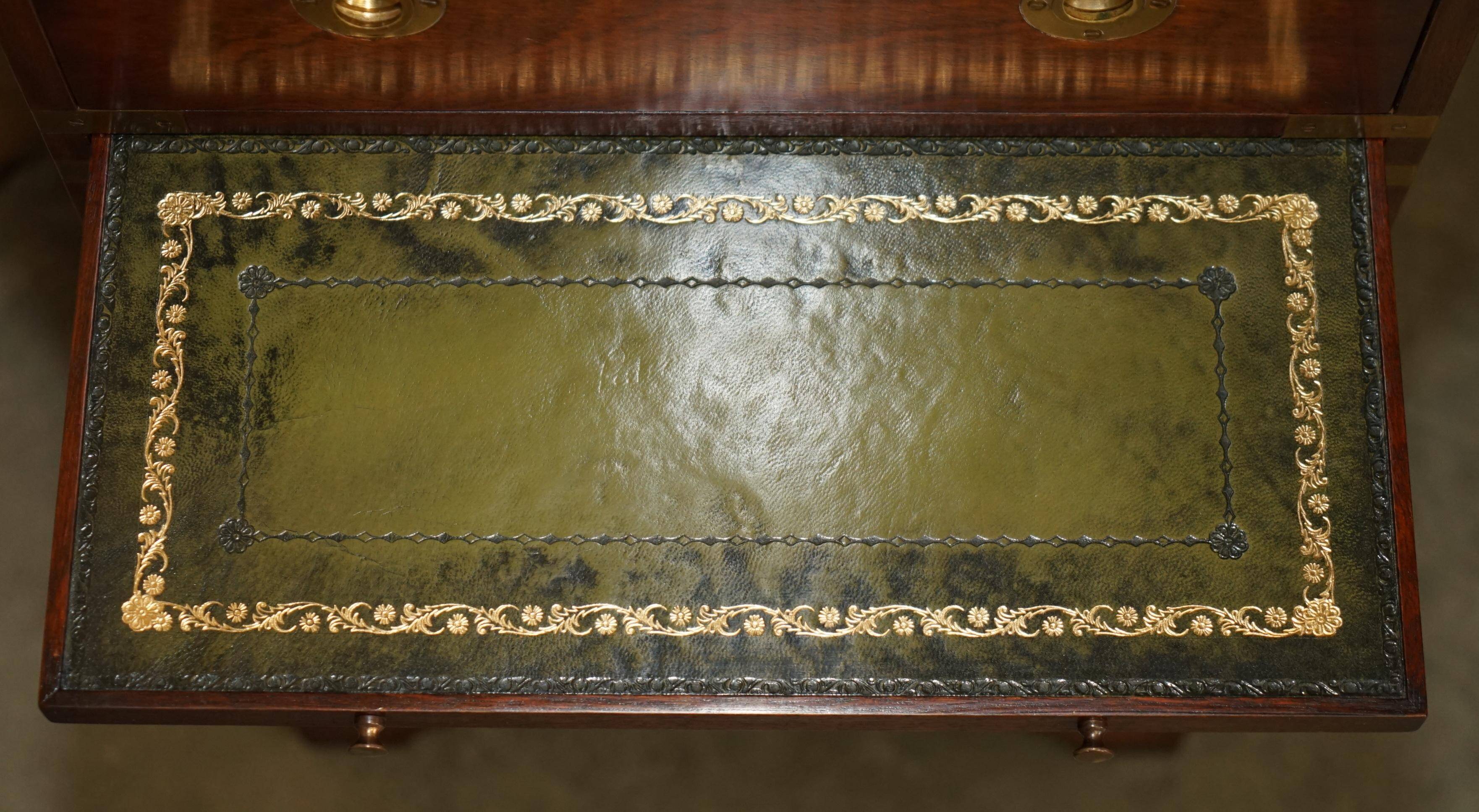 Pair of vintage military campaign high chests of drawers with leather tops.