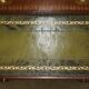 Pair of vintage military campaign high chests of drawers with leather tops.