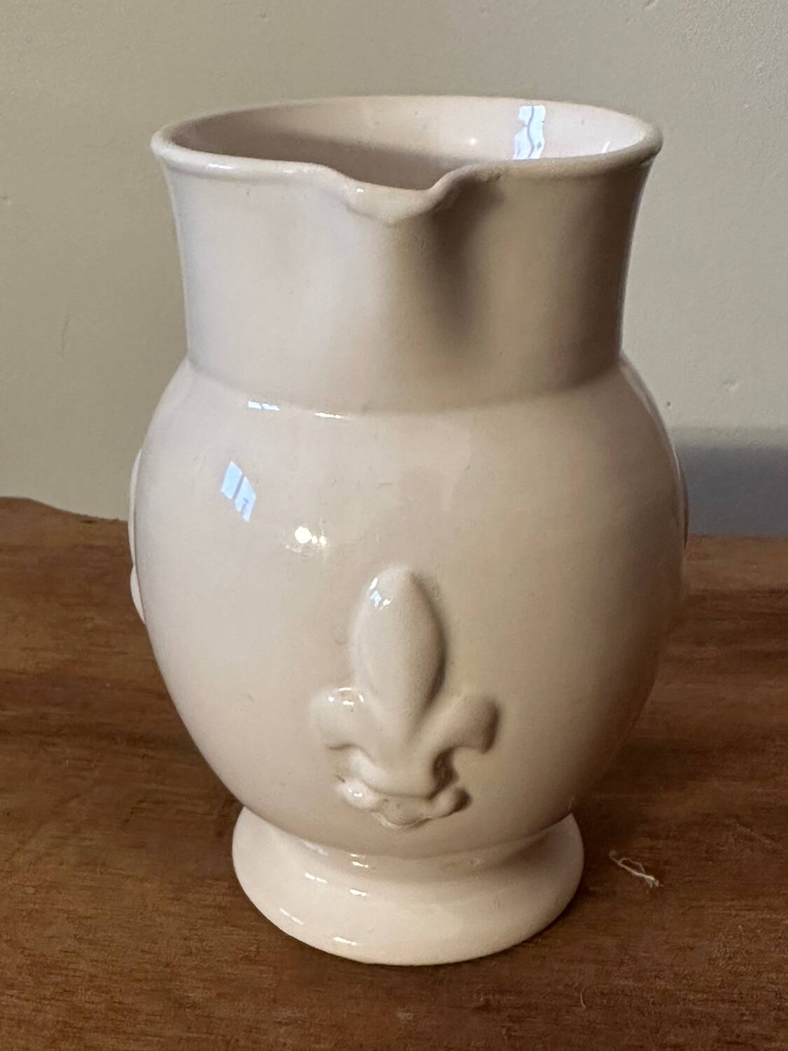 Old white ceramic pitcher with fleur de lys in relief h 14 cm