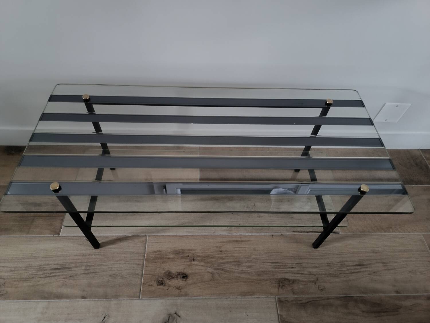 Vintage coffee table in glass and mirror strips.