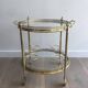 Round brass rolling table attributed to Maison Jansen