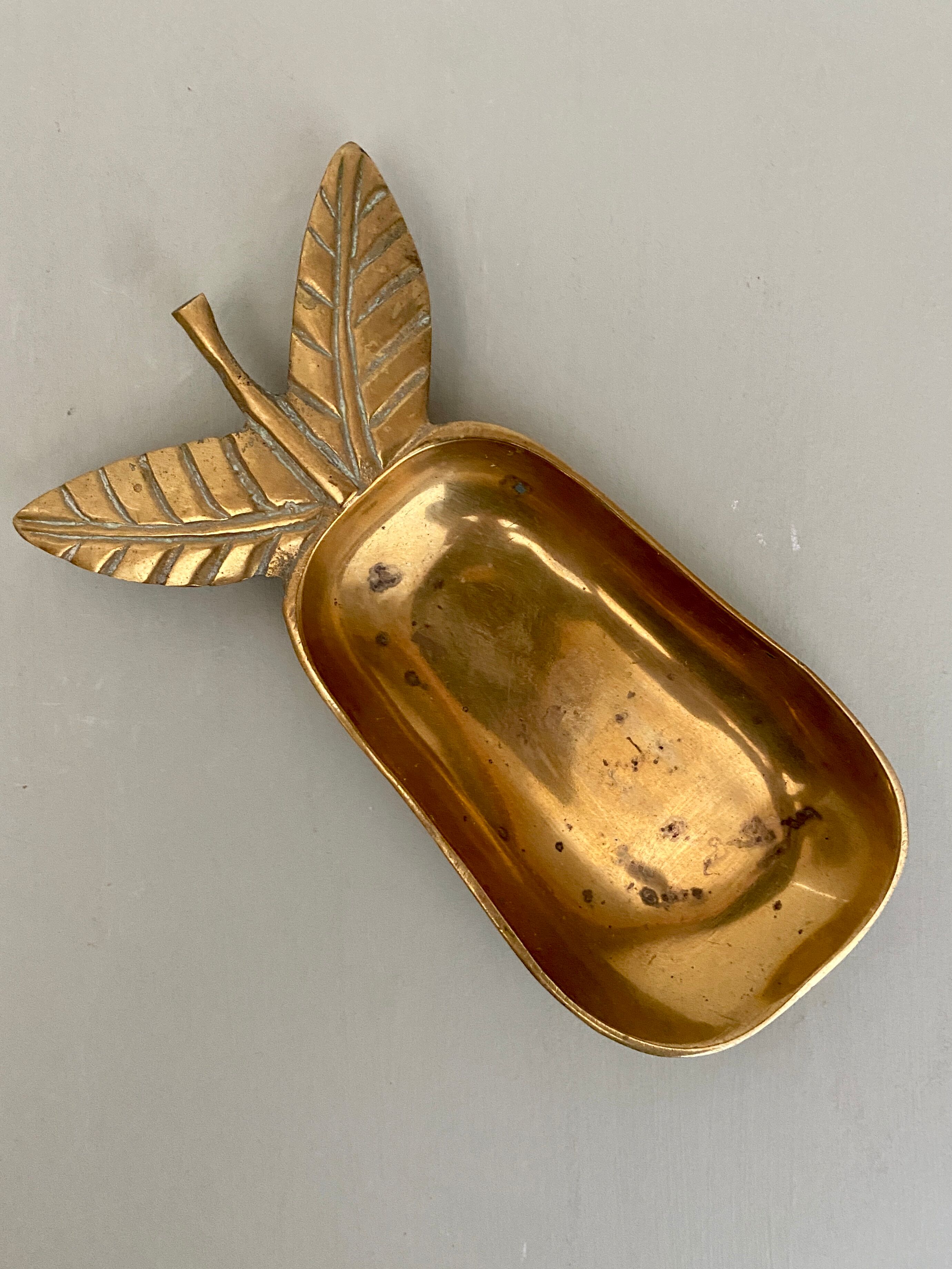 Empty vintage pear-shaped brass pocket