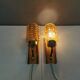 A set of wall lamps in teak wood, with amber colored glass