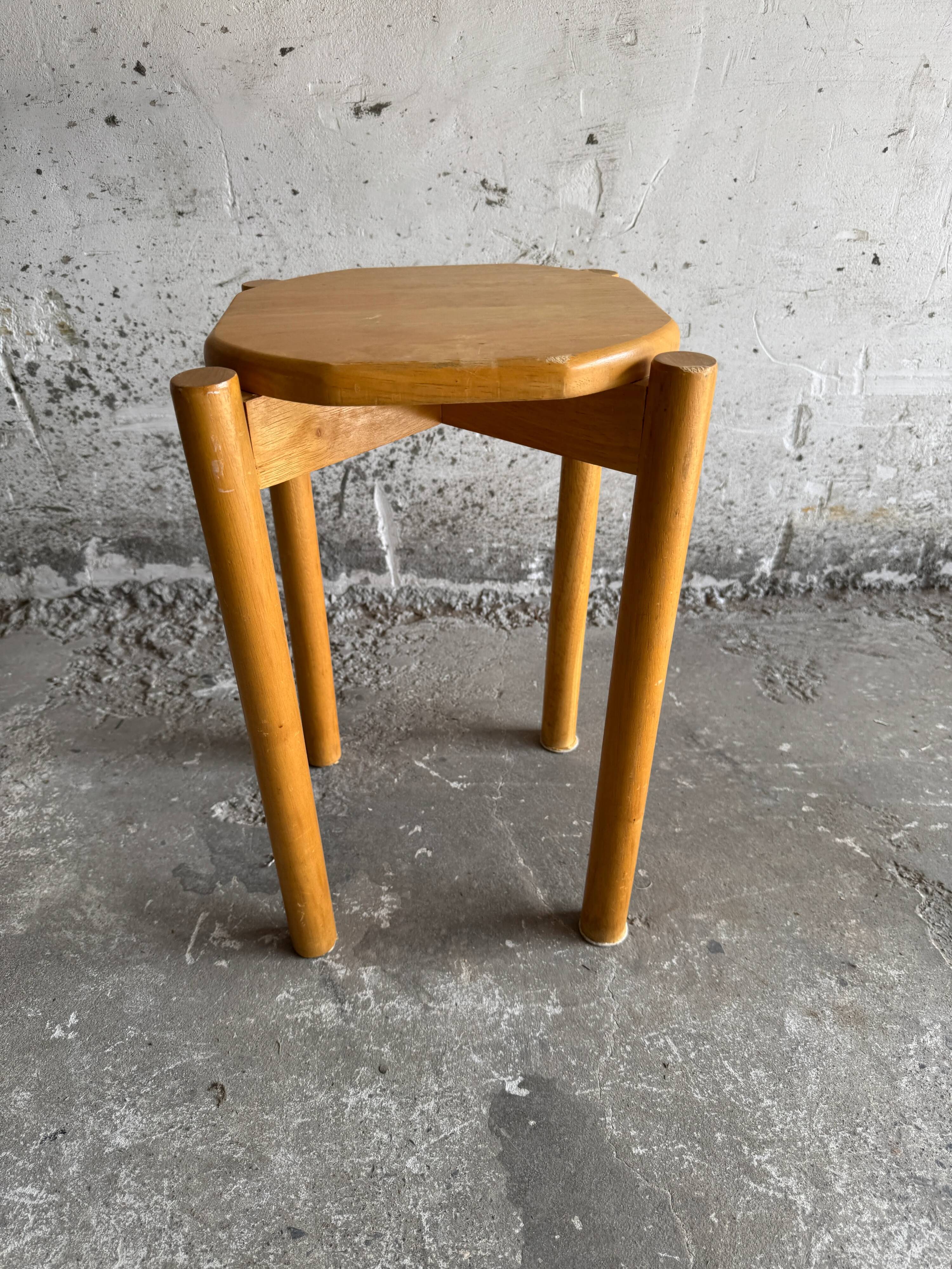 Vintage solid wood stool with an organic-shaped seat.
