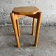 Vintage solid wood stool with an organic-shaped seat.