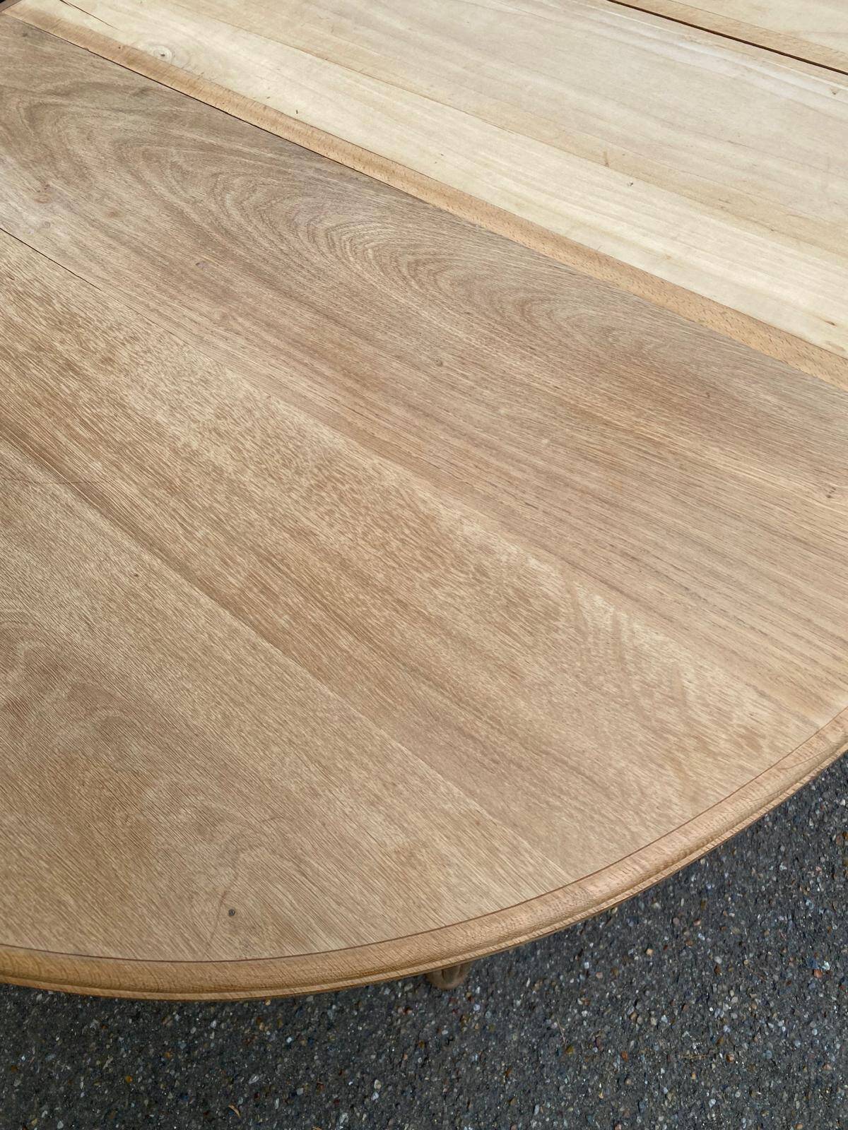 Large stripped solid oak dining table in Louis XVI style with 3 extensions.