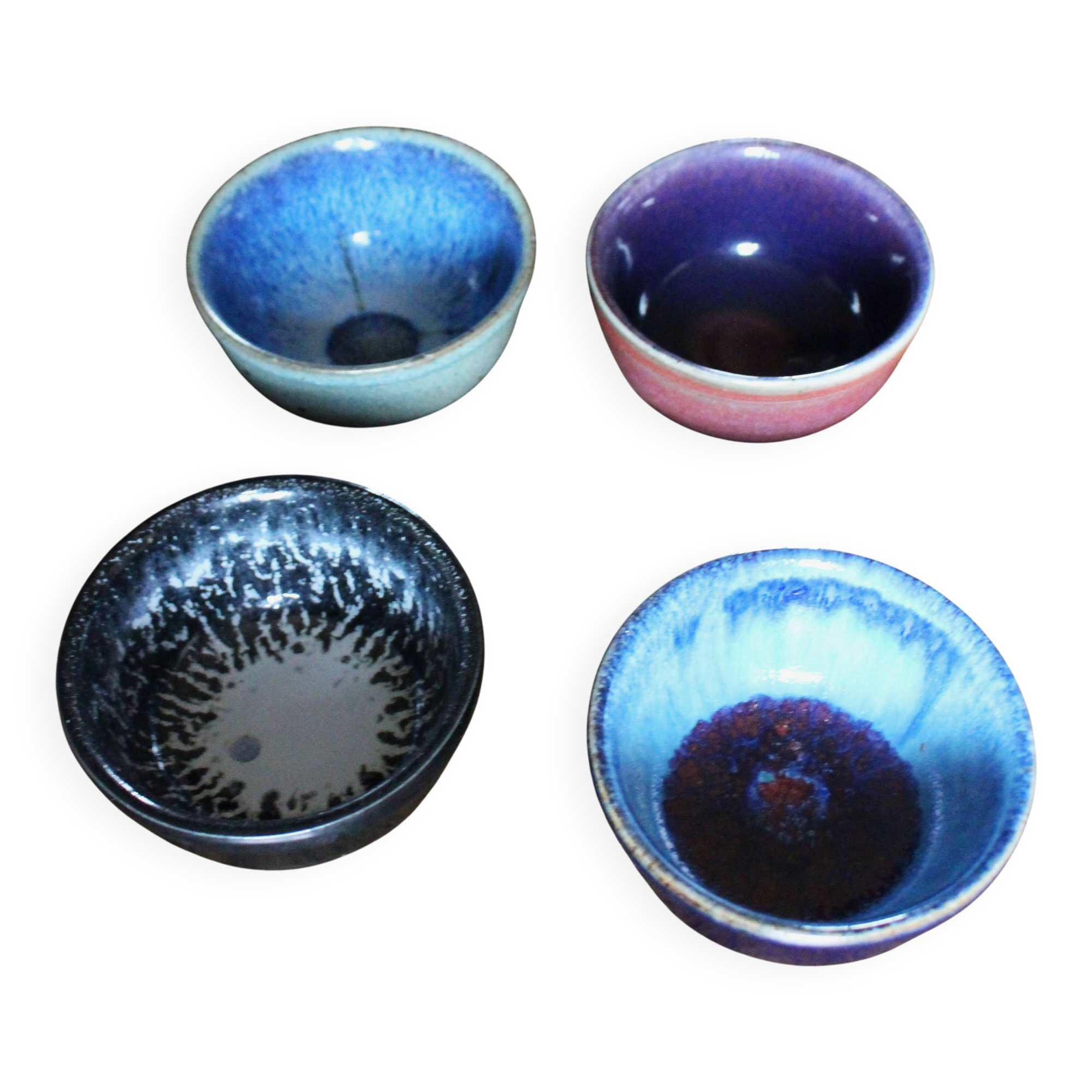 A set of 4 pottery bowls in coloured glaze.