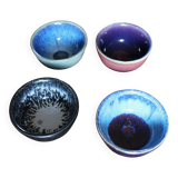 A set of 4 pottery bowls in coloured glaze.