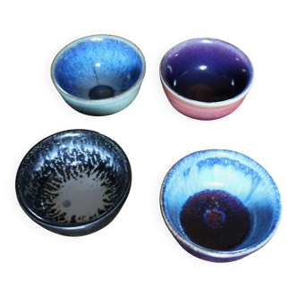 A set of 4 pottery bowls in coloured glaze.