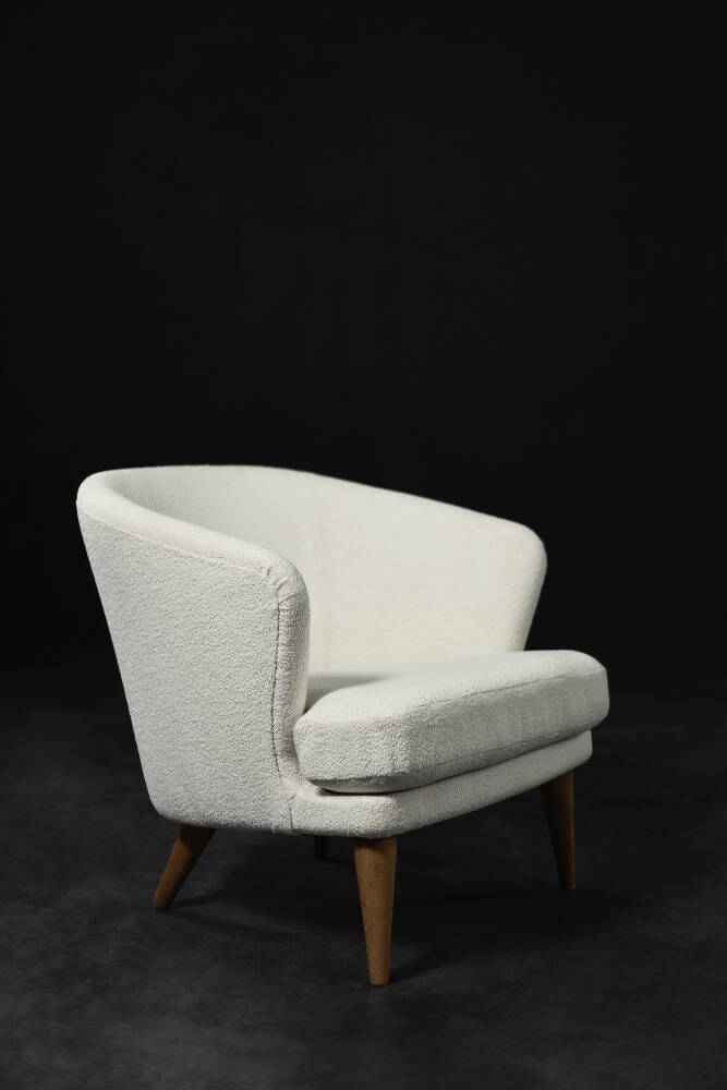 Low oak armchair with modern mid-century Scandinavian fabric and rounded backrest, 1960s.