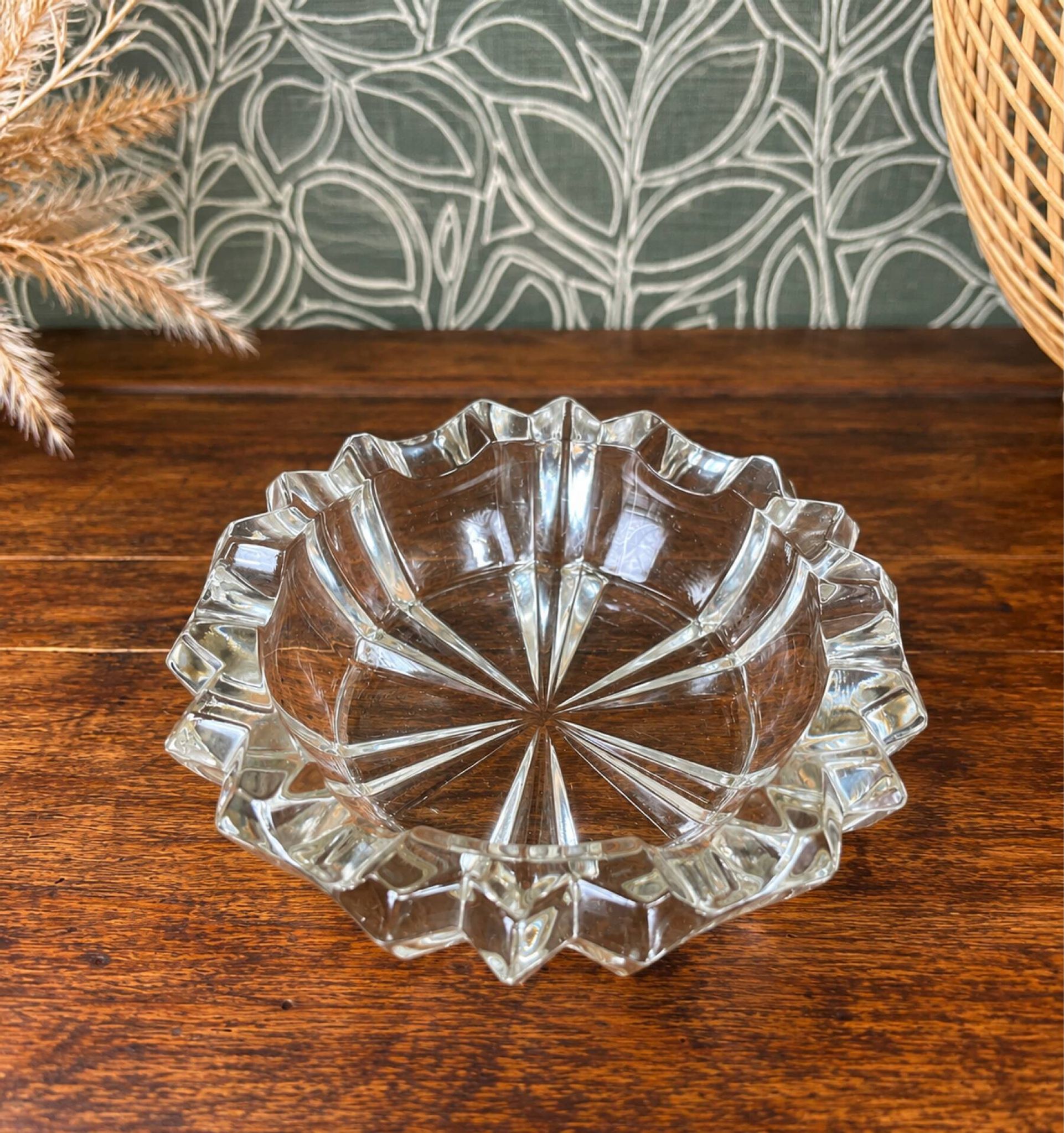 Vintage transparent glass ashtray with star decoration.