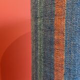 "Stoneware Bottle Lamp" with a multicoloured blue lampshade handwoven in India.