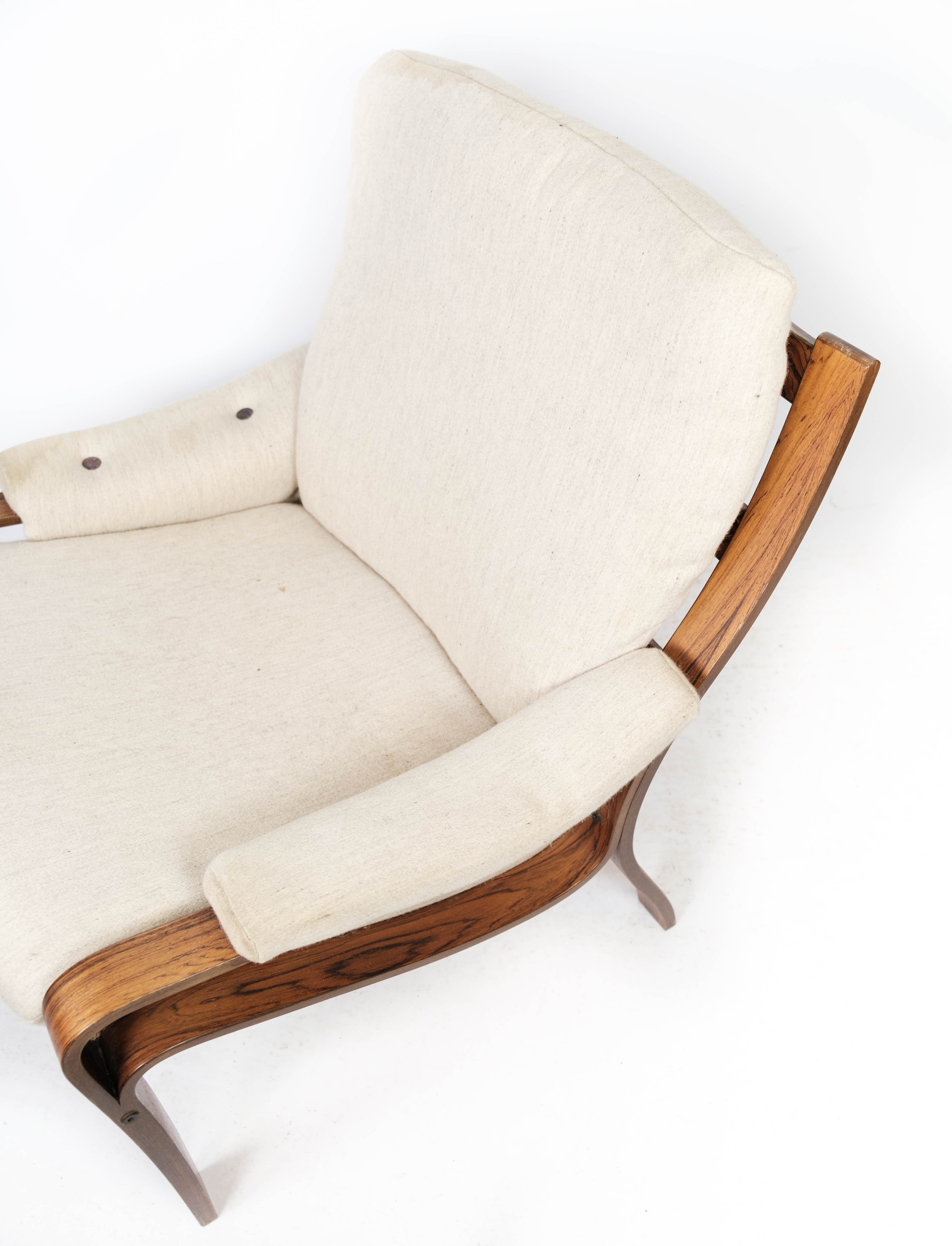 Armchair in rosewood and upholstered with light fabric, of Danish design, 1960s