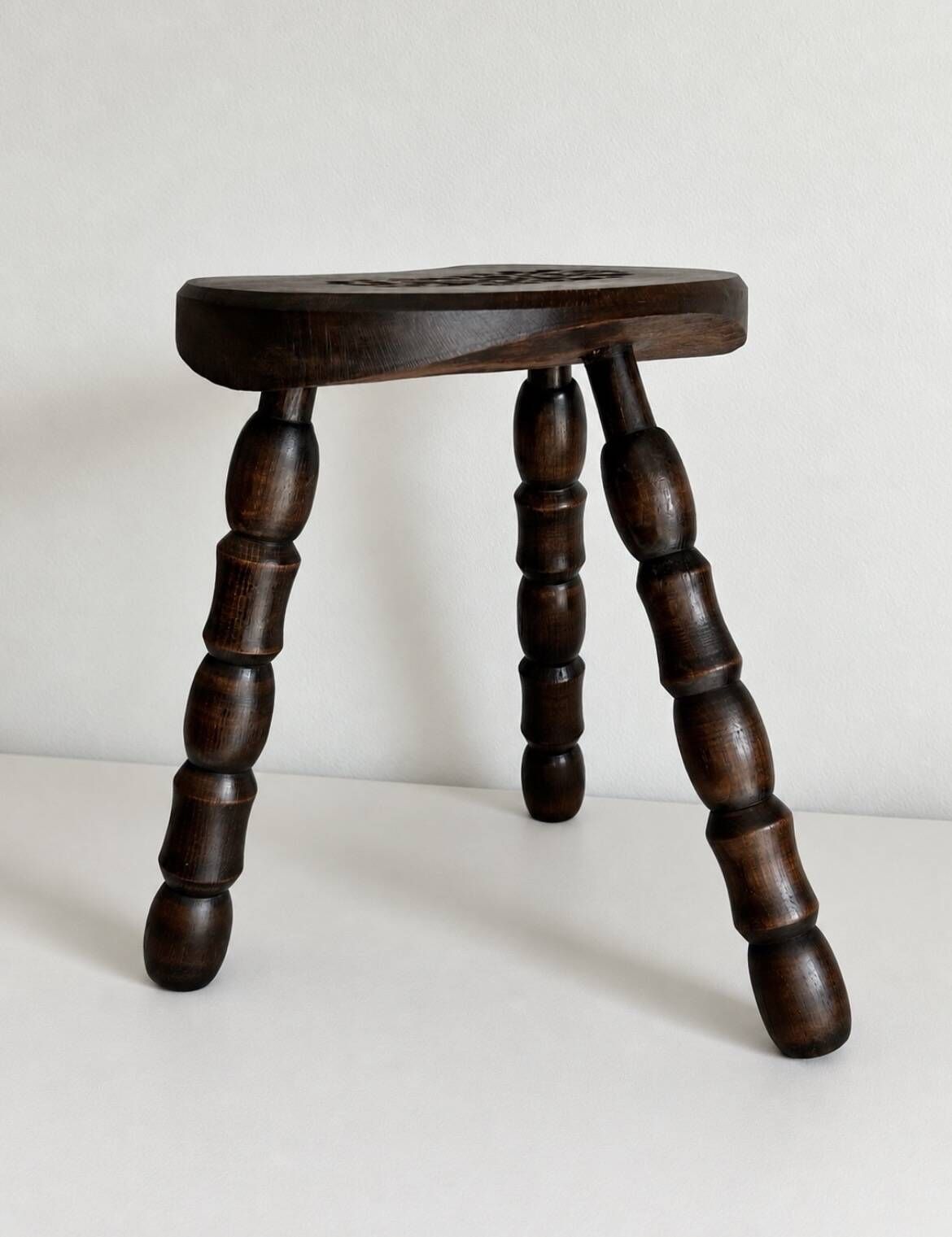 Restored dark wood tripod stool, bobbin leg, elegant furniture.