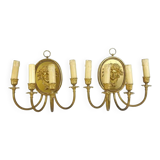 Pair of wall sconces with a relief decoration of a Bacchus mask.