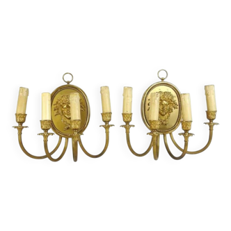 Pair of wall sconces with a relief decoration of a Bacchus mask.