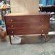 Vintage commode with tapered legs.