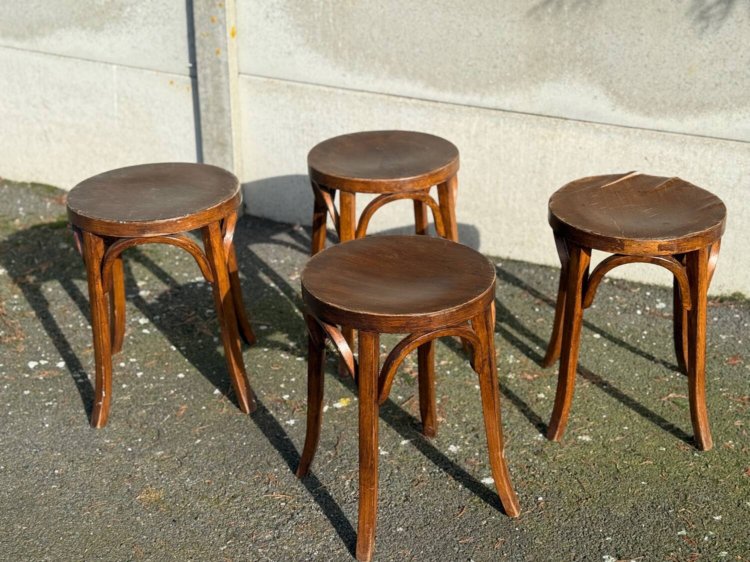 Set of four curved wooden stools stamped Baumann model 92.
