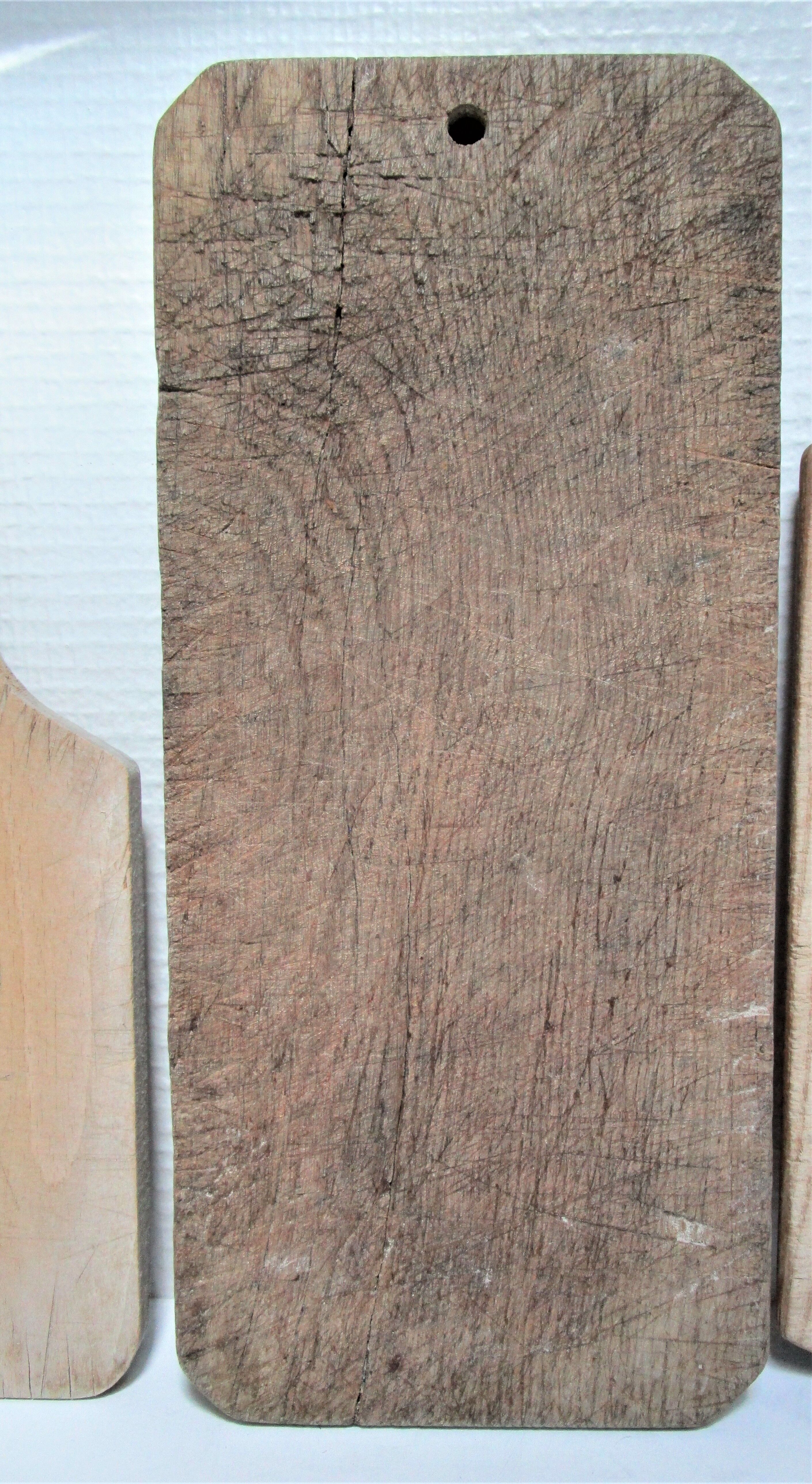 three vintage patinated solid wood cutting boards
