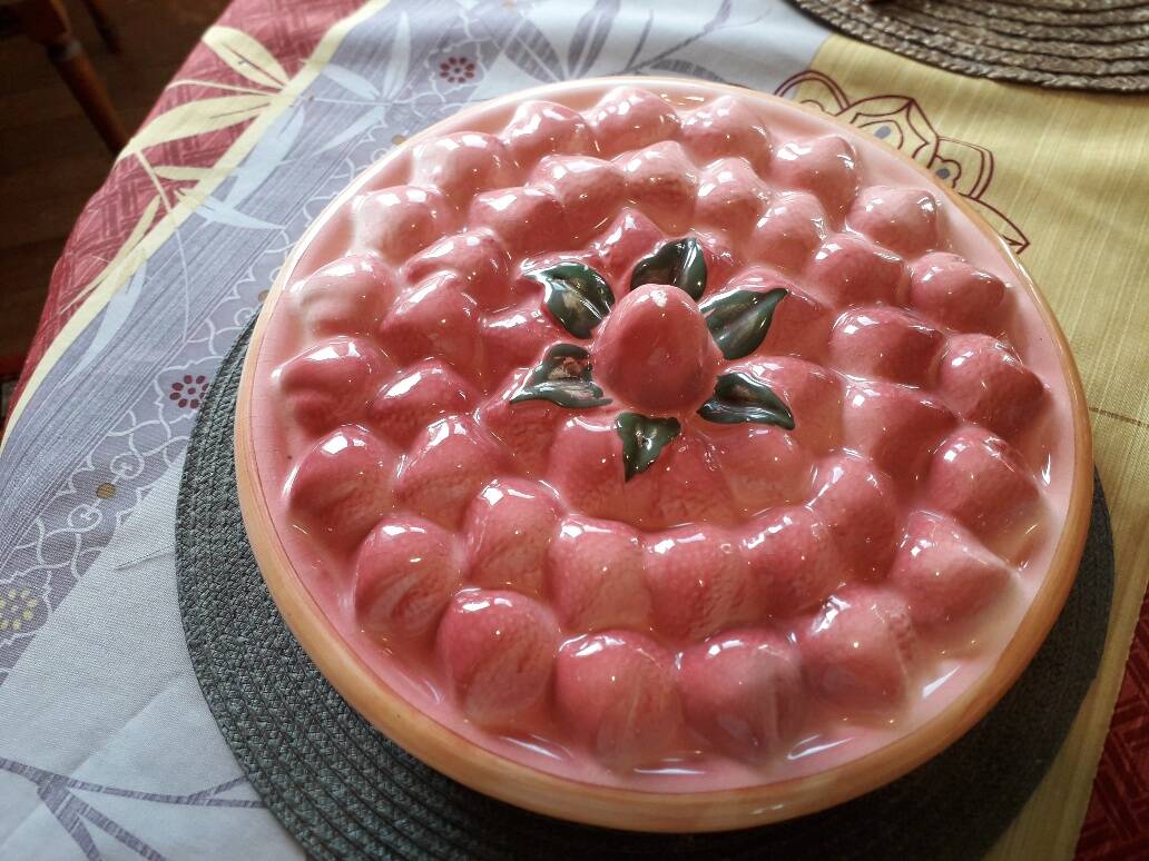Glazed ceramic dessert plate with strawberry design.