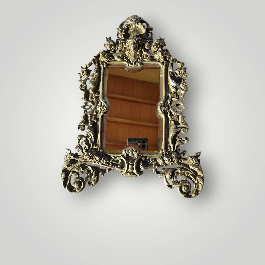 Gilded bronze wall mirror, beveled glass