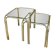 Pair of small nesting coffee tables in gold tubular metal & transparent glass tops